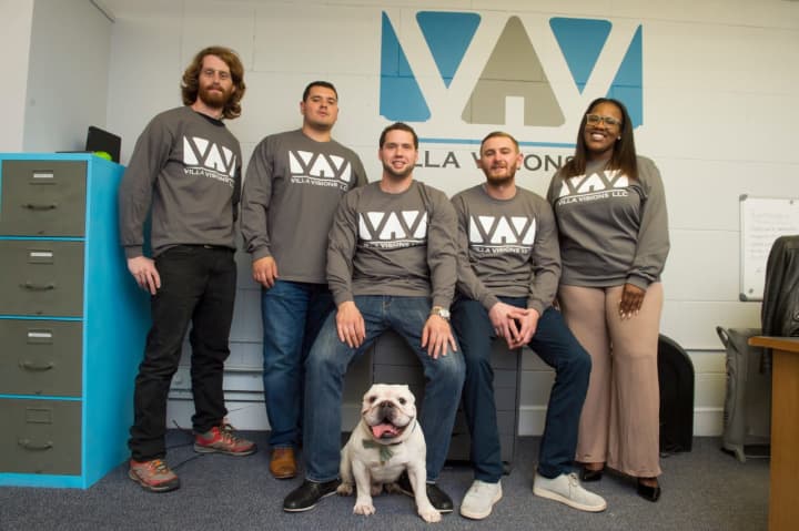 Travis Soine of Rutherford, center, and the Villa Visions team — plus company mascot, Nicks.