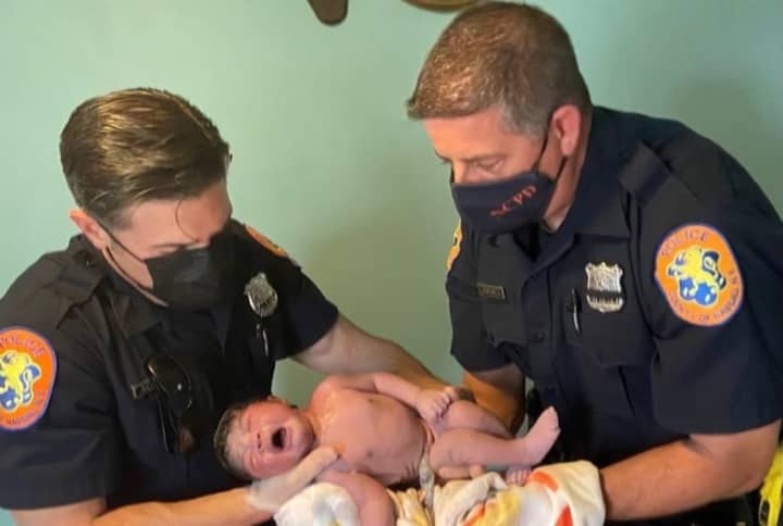 Two Nassau County officers helped deliver a baby girl when the Massapequa mother called for help.