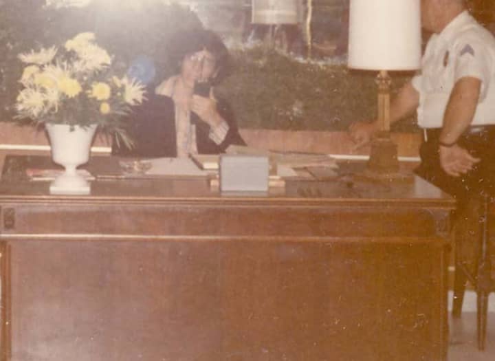 Ben Novack Jr. working with security at a desk in the lobby of the Fontainebleau in 1972