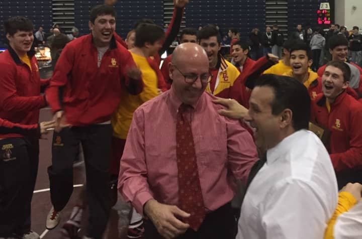 Bergen Catholic wrestling coach Dave Bell and assistant Dominick Spataro celebrate as the Crusaders won their fifth straight Non-Public A title.