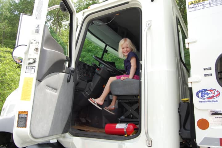 A girl sits in the cab of a big rig during Kent Public Library&#x27;s &quot;Big Truck and Community Vehicle Day&quot; on June 4.