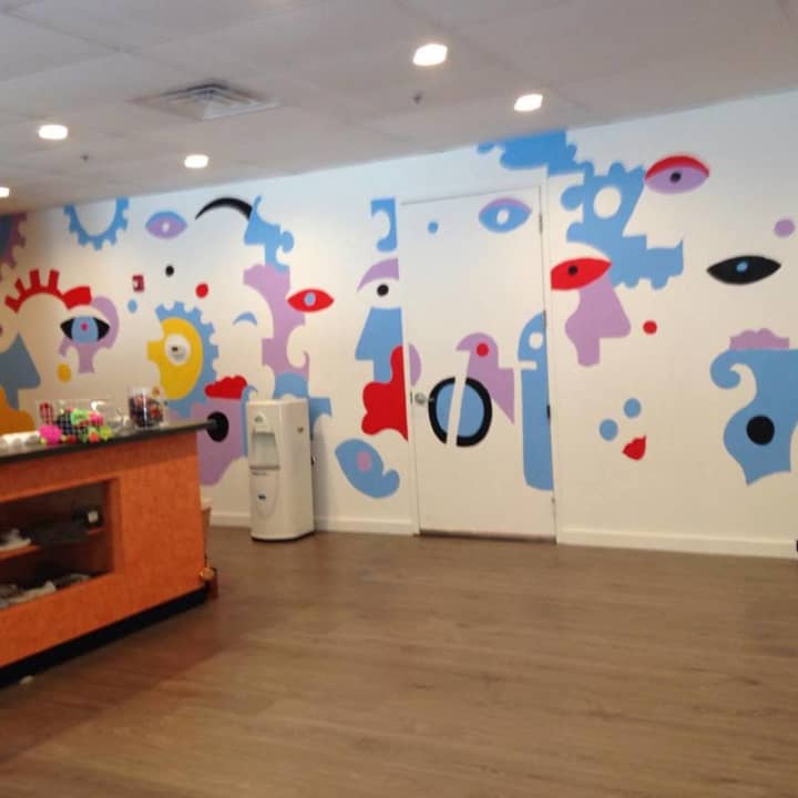 Billy The Artist will continue painting the mural at JoyRide Cycling Studio in Westport through Thursday. 