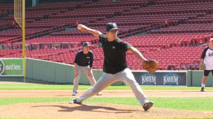 Former Columbia University pitcher and current baseball writer Bob Klapisch takes the mound at Fenway Park.