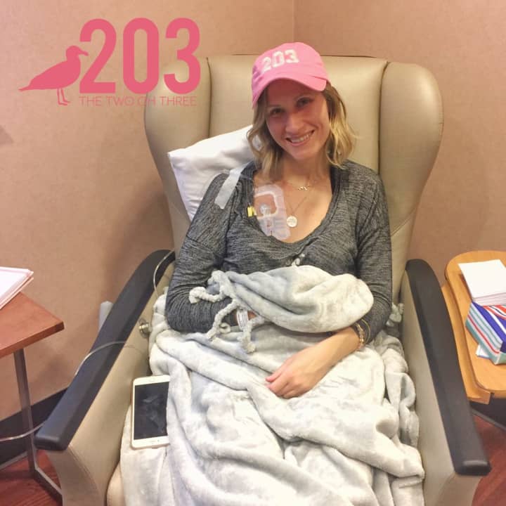 Stamford resident Bonnie Wilson, 25, wears a pink 203 hat on her first day of chemotherapy at Stamford Hospital this week. The hats are being sold by The Two Oh Three online company to raise money for her treatment.