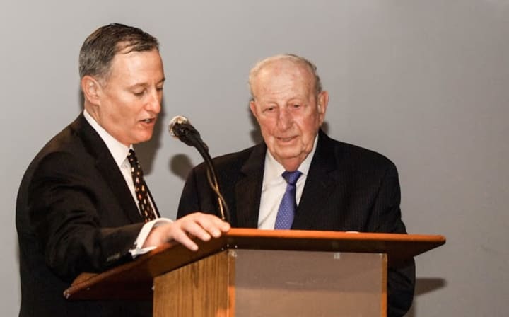 Brian Kriftcher, left, founder of Stamford Peace, presents the Community Legacy Award to Herm Alswanger.