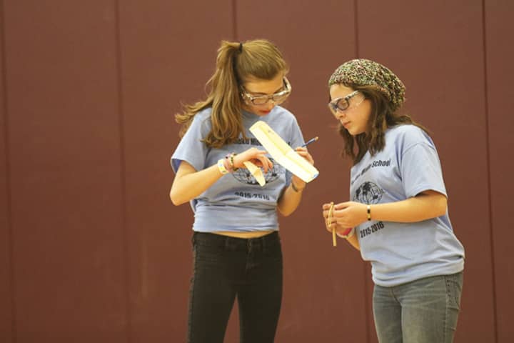 Westlake&#x27;s Brianna Calamis and Taylor Chiera built a balsa wood plane powered by elastic bands. The competition was to have their plane fly in the air the longest.