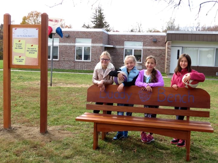 Meadow Pond Elementary School fourth-grade students, from left, Julia Johnston, Brooke Habinowski, Talia Blechman and Kristina Fonseca connect at the school’s new Buddy Bench