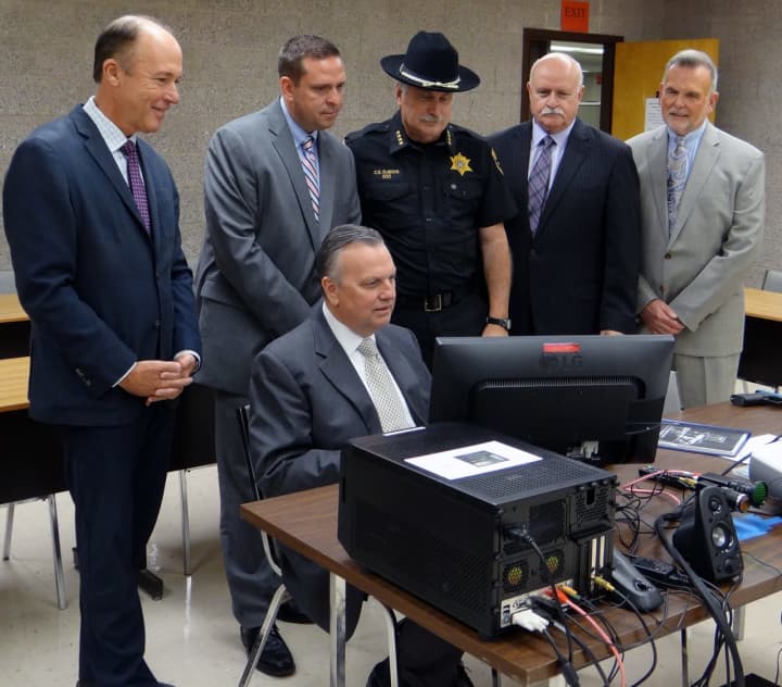 SUNY Orange criminal justice professor Robert Cacciatore, demonstrates the college’s new Response to Resistance Simulator, designed to train local law enforcement officers.