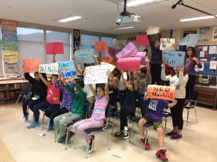 Fifth-graders at the Seven Bridges Middle School in Chappaqua hold up signs of encouragement while Skyping with Ned Norton, one of the everyday heroes featured on CNN&#x27;s 10th anniversary special, &quot;CNN Heroes: An All-Star Tribute.&quot;