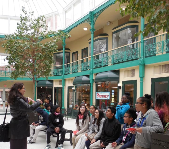 Janet Zamparo teaching peer docent students inside the Arcade Mall in Bridgeport.