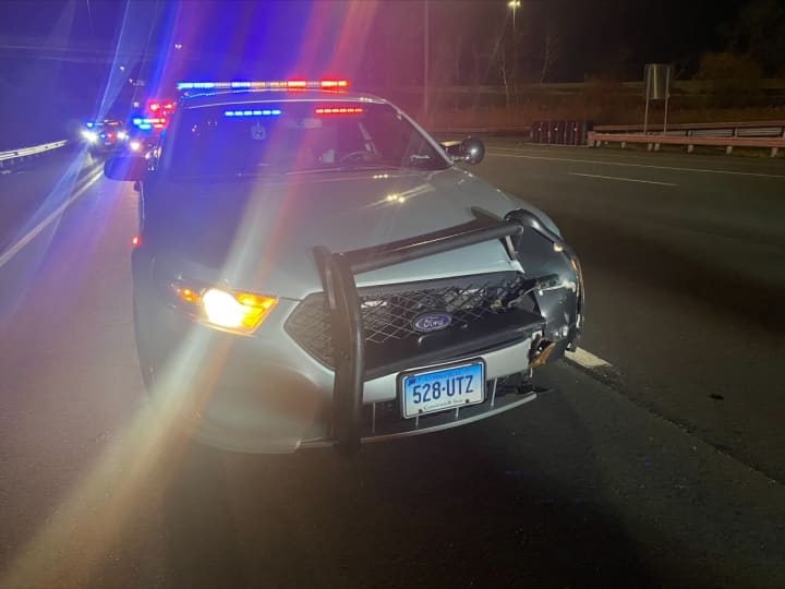 A 36-year-old man was charged after police said he drove the wrong way on a highway and struck a Connecticut State Police cruiser.