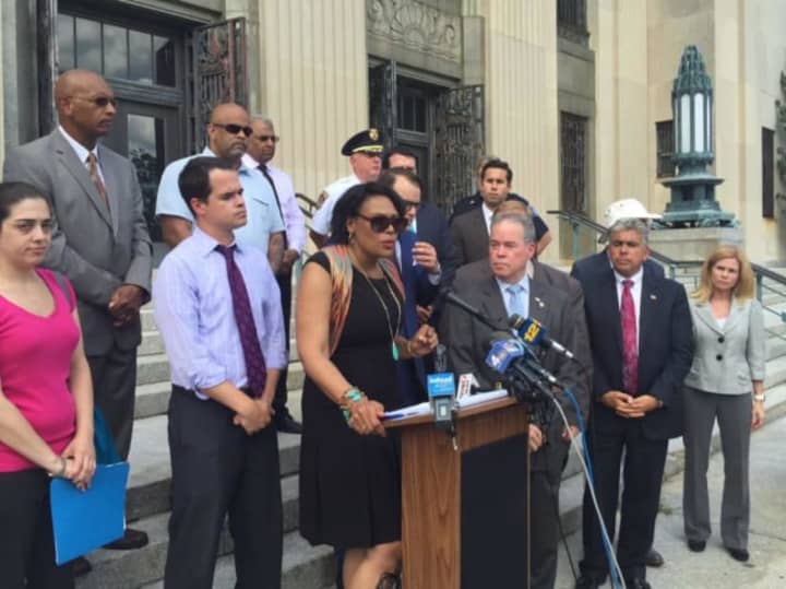State and local officials speak at a rally following a fire-bombing incident at the homes of two rabbis.