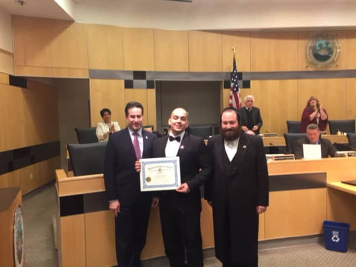 Joey Resto holding his Distinction of Honor award with Rockland County Legislature Aron Wieder (right) and Rockland County Legislature Chairman Alden Wolfe (left).