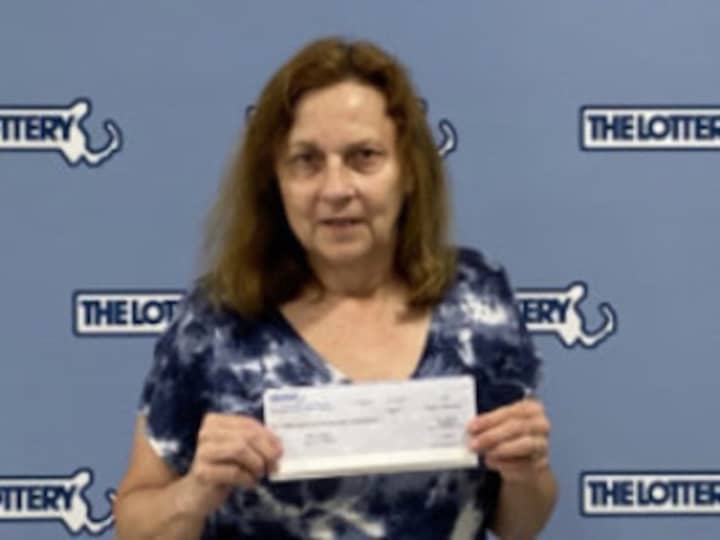 Cheryl Cormier showing off her $1 million check.