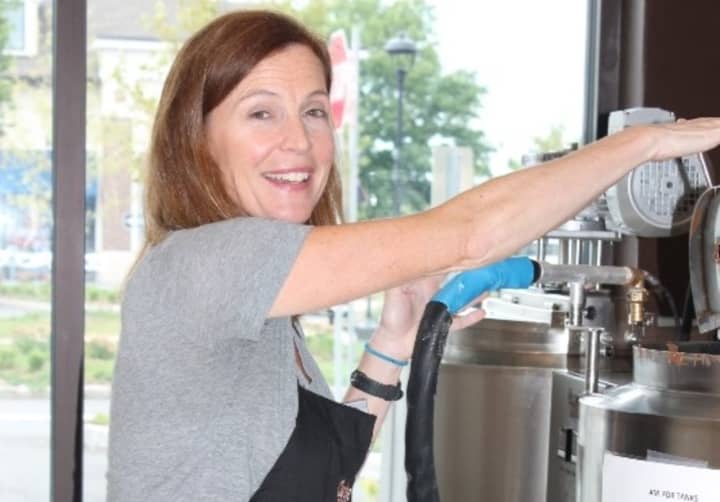 Andrea V. Collins at a milk chocolate tempering machine 