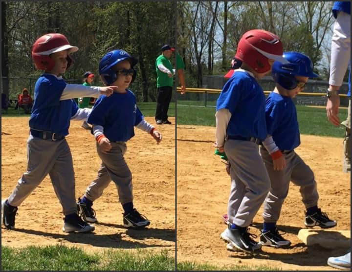 Marcello helps Frankie, 5, around the bases at their Washington Township T-ball game.