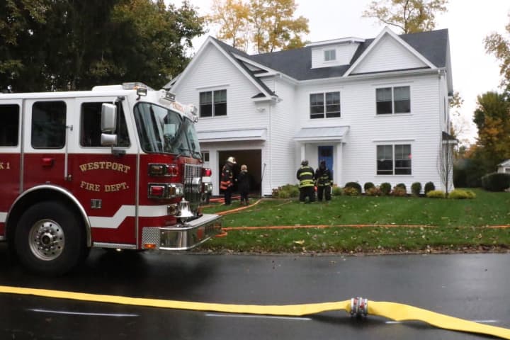 Westport firefighters respond to a blaze at 9 Colonial Road on Monday morning.