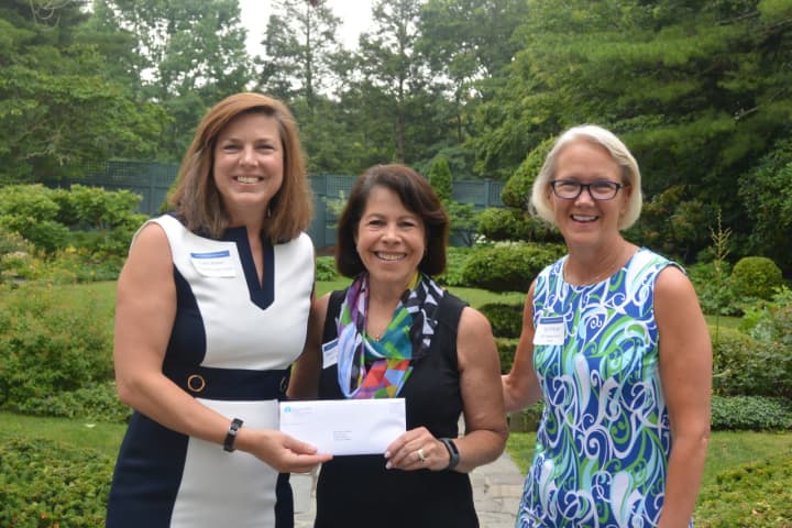 Shari Shapiro, executive director of Kids in Crisis, center, receives a check from Carrie Bernier (left) and Amy Wilkinson (right) of The Community Fund of Darien.