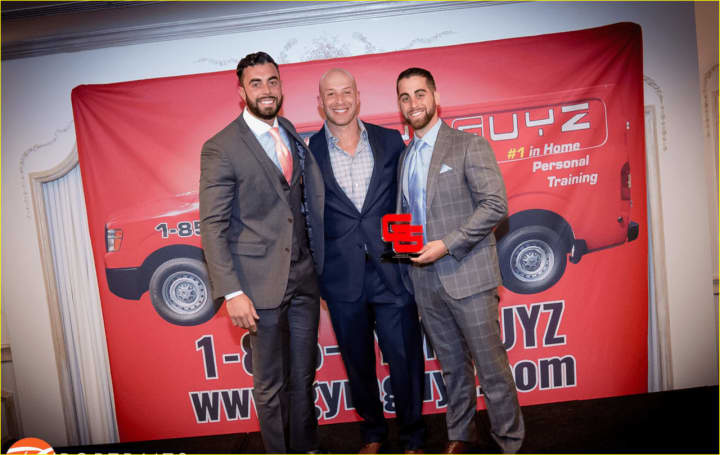 James Bonavita, left, with GYMGUYZ CEO Josh York, center and Sam Langer, right, with their &quot;Franchise of the Year&quot; award.