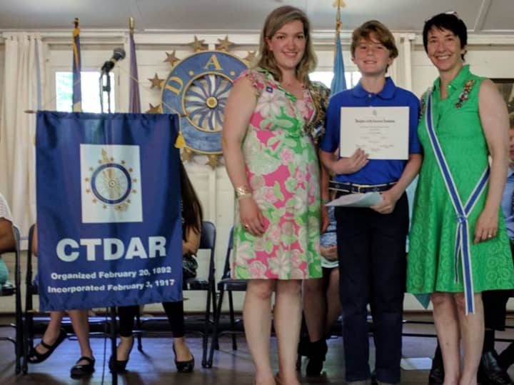 Good Wife’s River Chapter DAR Essay Contest winner Connor McNamara receives a certificate and pin from CTDAR American History Chairman Catherine Bue-Hebner and CTDAR Regent Alice Ridgway at the Connecticut State DAR Board of Management Meeting