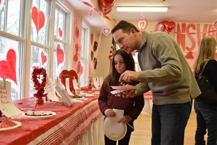 Westchester County Executive Rob Astorino and his daughter, Ashlin, check out the entries inn the Valentine&#x27;s cookie bake-off at the North Salem Volunteer Ambulance Corps Sunday.