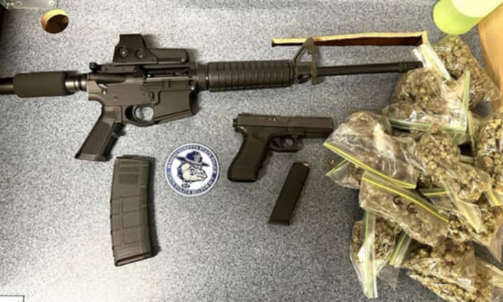 Weapons, ammo, and marijuana seized by police.