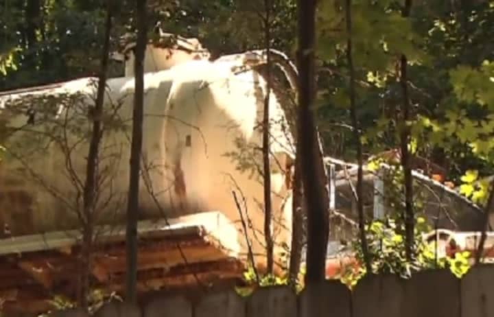 A Cortlandt Manor resident says his neighbor hasn’t removed the industrial equipment from his yard, including a rusted septic truck, that he was ordered to remove in 2008. 