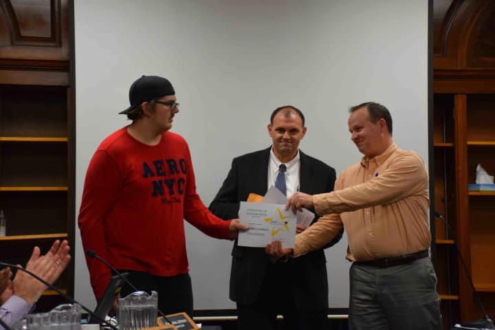 Jim Bellucci, Career Academy principal at BOCES, and Douglas Glickert, a BOCES board member, presented Kristopher Gordineer with the Student of Distinction certificate Dec. 3 at the Croton-Harmon  Board of Education meeting.