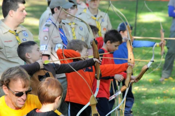 James Ronan, Marc Desforges, and Jacques Desforges show off their archery skills at the Thunderbird Games in Croton Point Park, Croton-on-Hudson, N.Y.