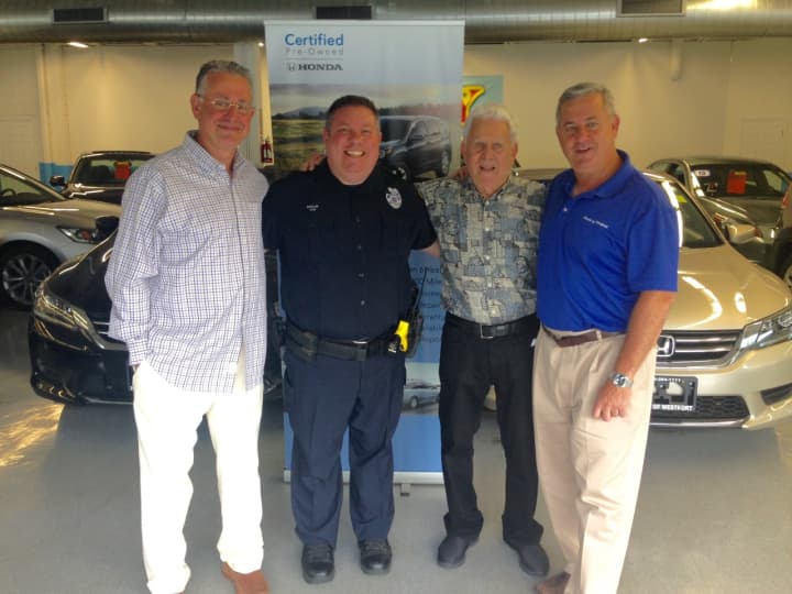(from left) Honda of Westport co-owner Steve Perkins, Officer Ned Batlin, Honda of Westport founder Dan Perkins and co-owner Evan Perkins.