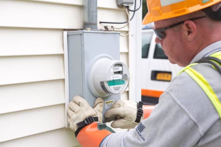 An O&amp;R employee installs one of the first smart meters.
