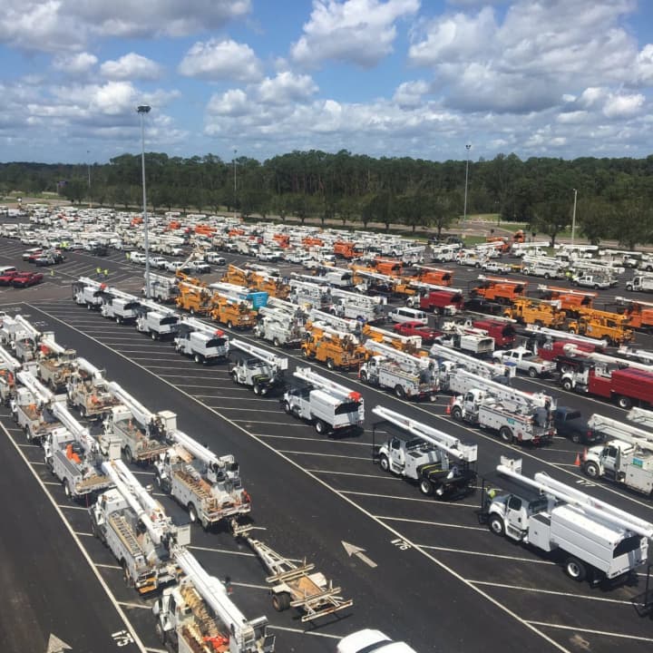 A convoy of Eversource trucks responding to a hurricane disaster.