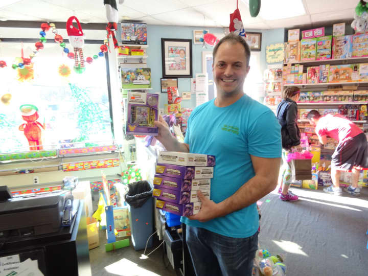 Ken Maietta, owner of Tons of Toys, preps for holiday toy shoppers. Mom-and-pop stores like his, he says, have had to adapt to compete with online shopping and big-box stores.