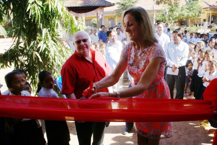 Cathy Zahn cuts the ribbon on the school in Cambodia she raised money to build.