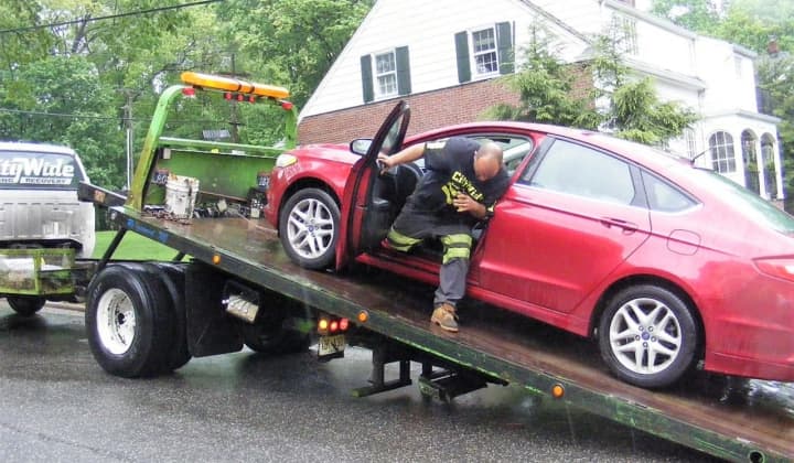 A flatbed tow truck removed the four-door Ford Fusion.