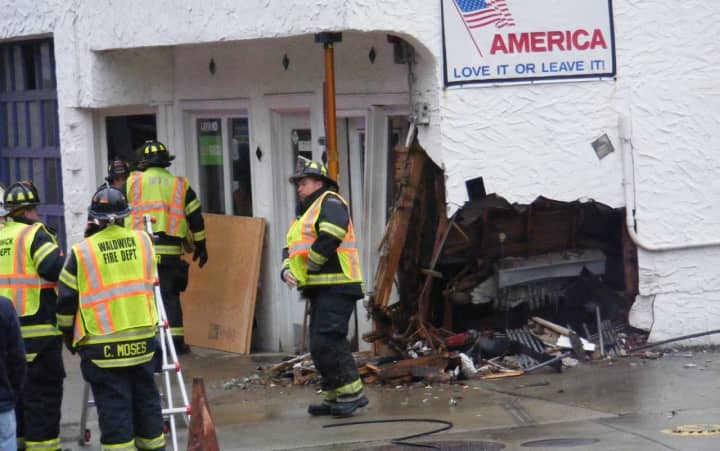 Waldwick firefighters worked to stabilize the Crescent Avenue building after the van was removed by a flatbed tow truck.
