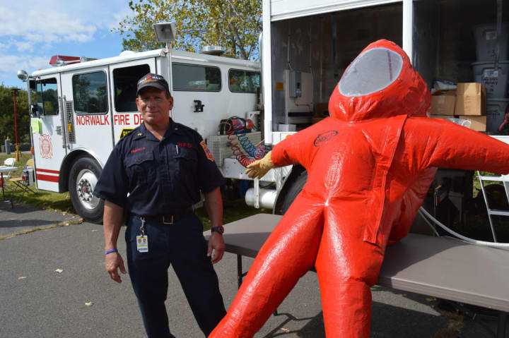Norwalk firefighter Mike Fratello explains an inflated Type A hazardous materials suit.