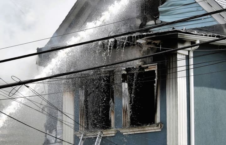 The fire apparently ignited on the second floor and shot through the upper-floor windows of one of the various wood-frame, multi-family homes on Knickerbocker Avenue in Paterson.