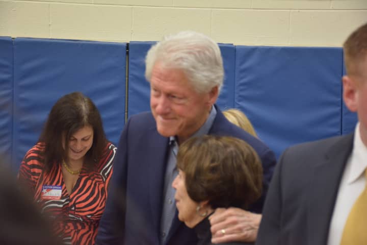 Former President Bill Clinton embraces as supporter as he and his wife, Democratic presidential candidate Hillary Clinton, visit their polling place last week in Chappaqua to vote in the New York Democratic primary.