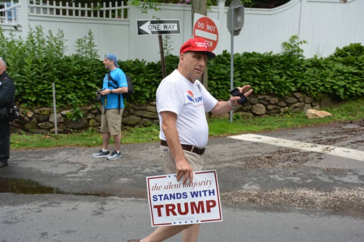 John Nadler makes his presence known a short distance away from Hillary Clinton prior to the start of New Castle&#x27;s Memorial Day parade. The 63-year-old Chappaqua resident backs Bedford&#x27;s Donald Trump.