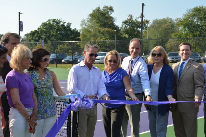 Community members, including Katonah-Lewisboro officials and elected officials, pose for photos at a ribbon-cutting ceremony or the John Jay tennis courts.