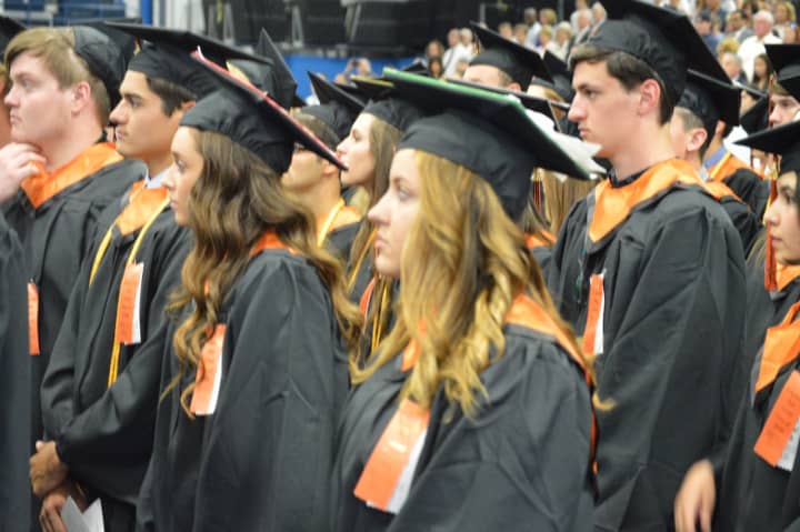 Stundents line up in black and orange for the Ridgefield High graduation Friday at Western Connecticut State University.