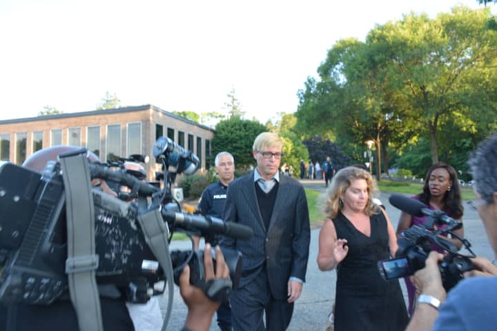Christopher Schraufnagel and his attorney, Stacey Richman, are surrounded by a media scrum as they leave New Castle Justice Court in downtown Chappaqua on July 14.