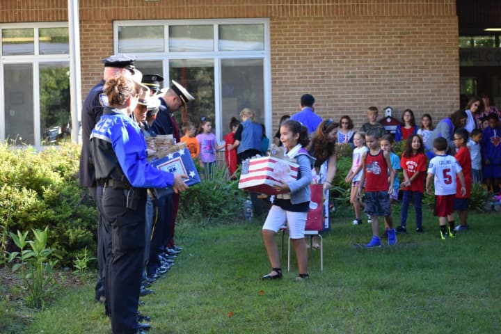 Students at Buchanan-Verplanck Elementary School presented gift boxes to representatives from local police, fire and EMT departments.