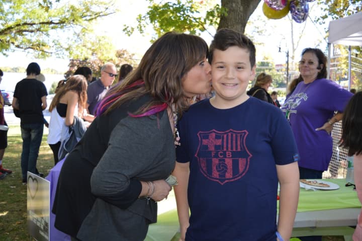 Pet ResQ founder Robyn Urman thanks 12-year-old Jon McKiernan for his contribution. 