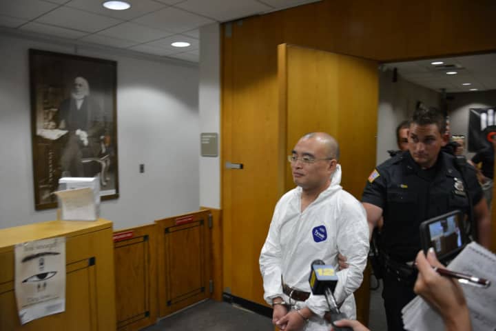 Hengjun Chao is escorted by New Castle Police following his court arraignment. Chao is the suspect in a shooting a Lange&#x27;s deli in Chappaqua.