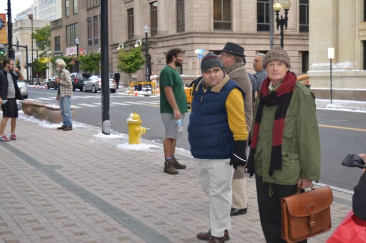 Bundled-up extras mingled with crew members in shorts at McLevy Green Tuesday.