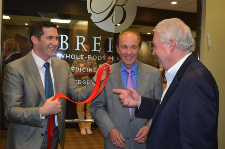 Drs. Adam, left, and Mark Breiner, center, share a laugh with Fairfield First Selectman Michael Tetreau.