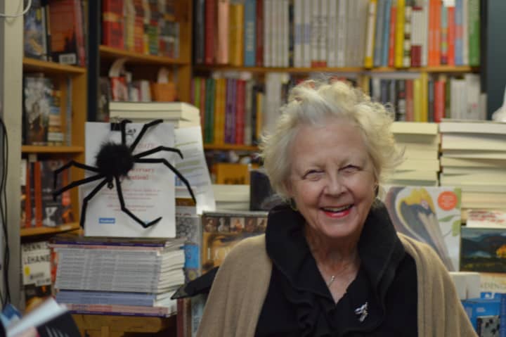 Diane Garrett of Diane&#x27;s Books in Greenwich greets a customer in her store Friday. The store, which was decorated for a Halloween party, is celebrating its 25th year in business. 