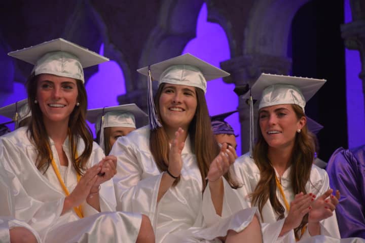 A group of John Jay High School graduates offer a round of applause at the 2016 commencement.